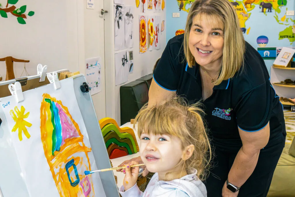 Preschool child engaged in painting at Little Gumnuts